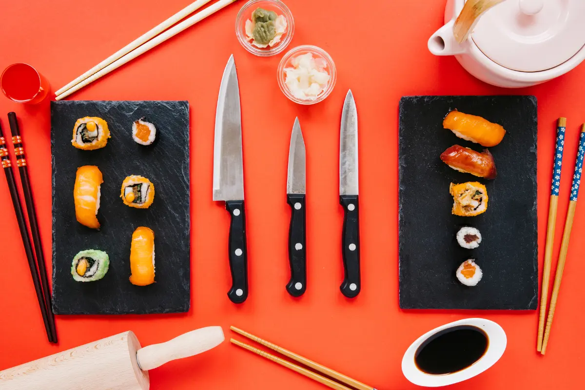 A vibrant still life capturing the essence of Japanese cuisine, with sushi, chopsticks, and a steaming teapot set against a bold red tablecloth.